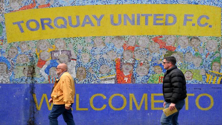 Torquay United fans make their way to a match